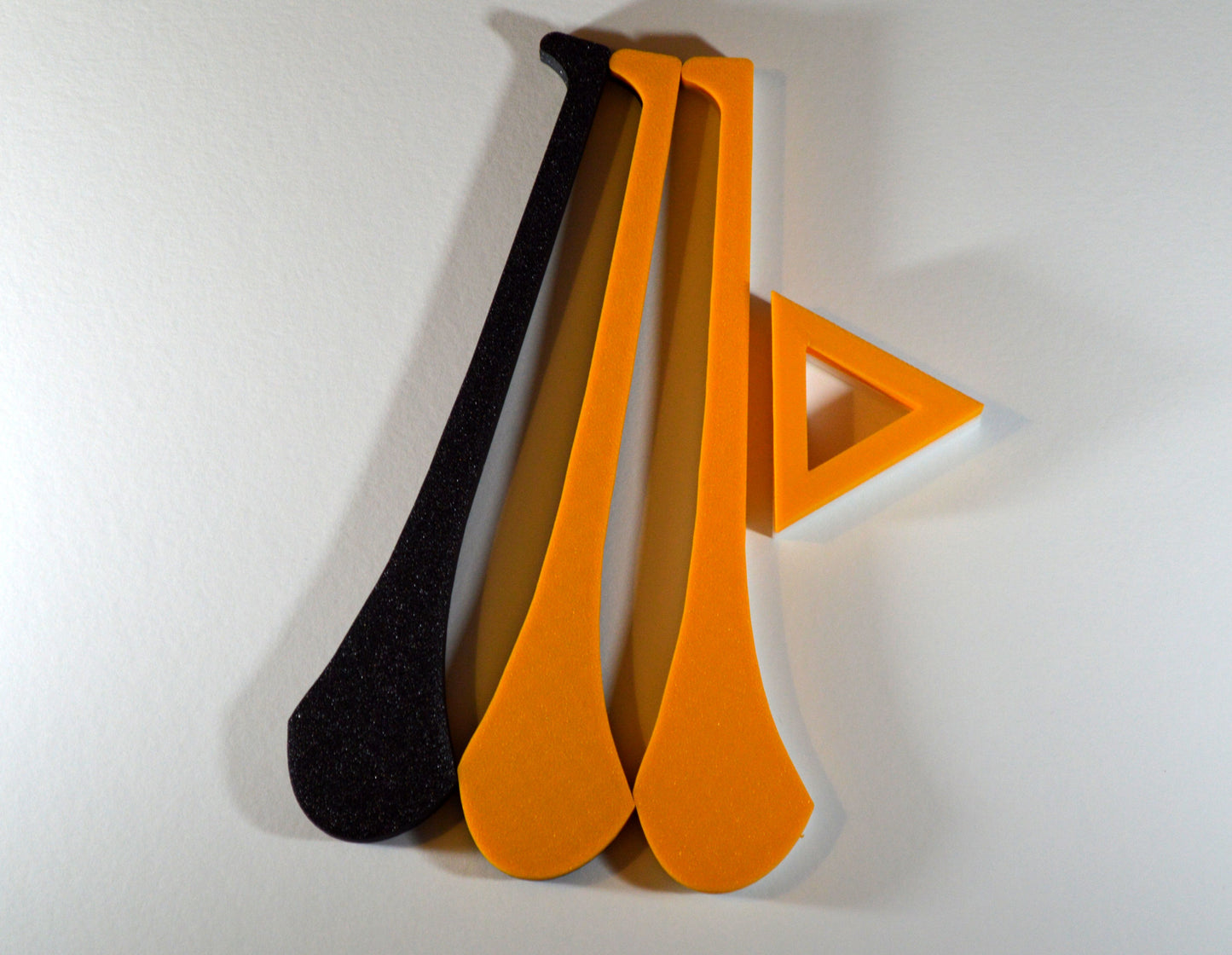 A display stand with a small hurley board, featuring black and amber colours.
