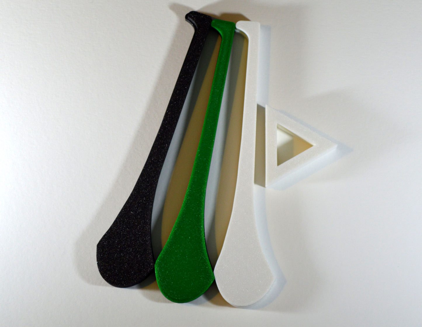 A display stand with a small hurley board, featuring black and amber colours.