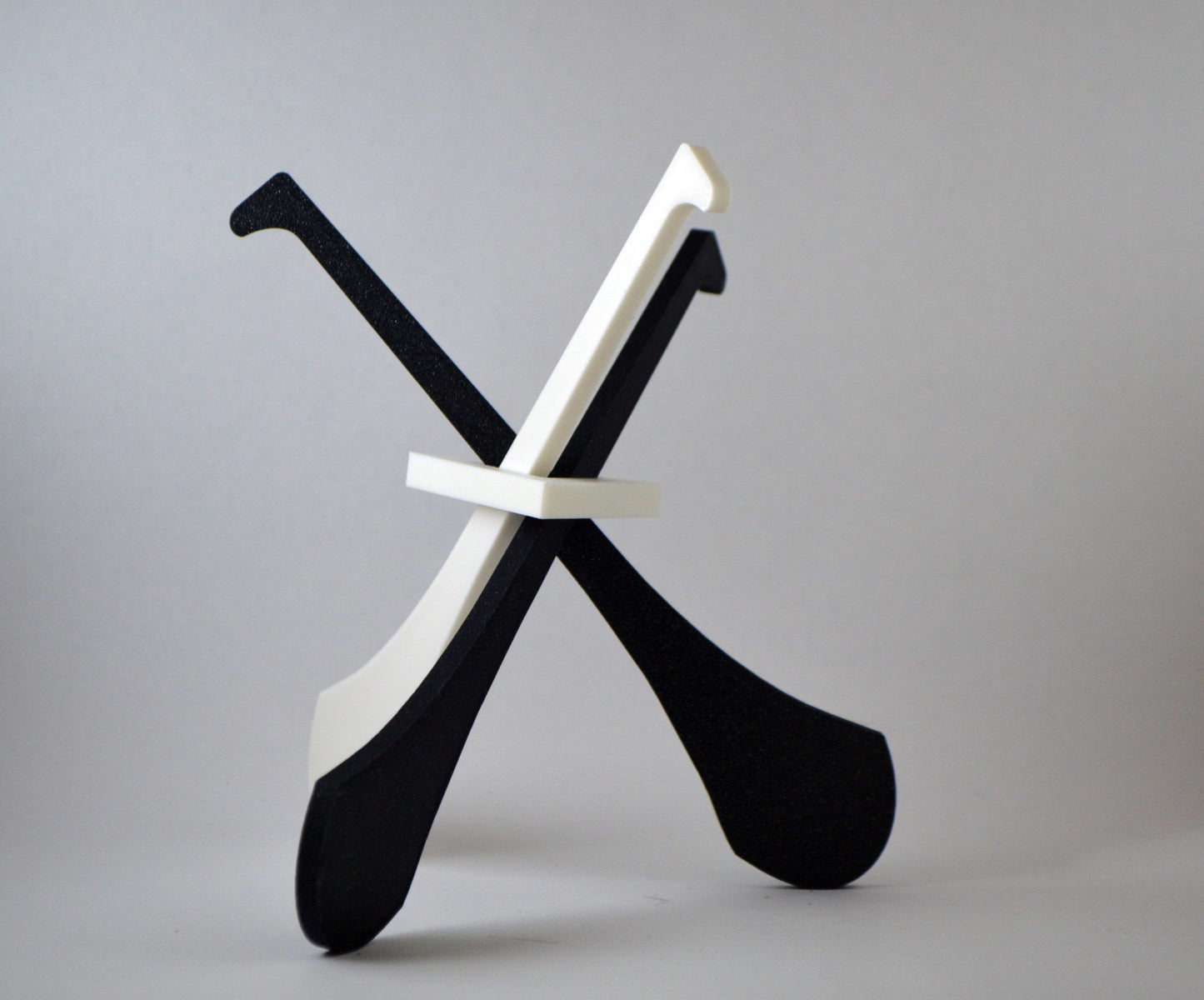 A display stand with a small hurley board, featuring black and white colours.