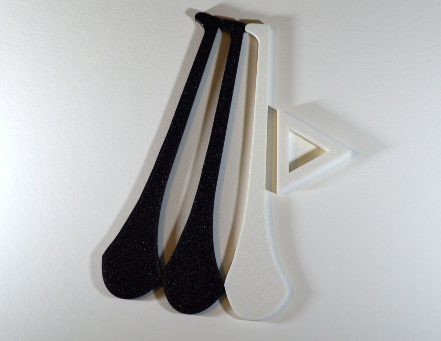 A display stand with a small hurley board, featuring black and white colours.