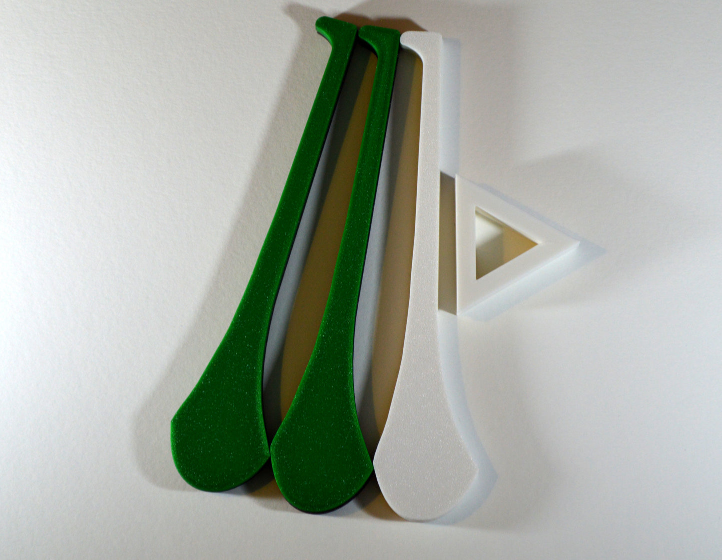 A display stand with a small hurley board, featuring green and white colours.