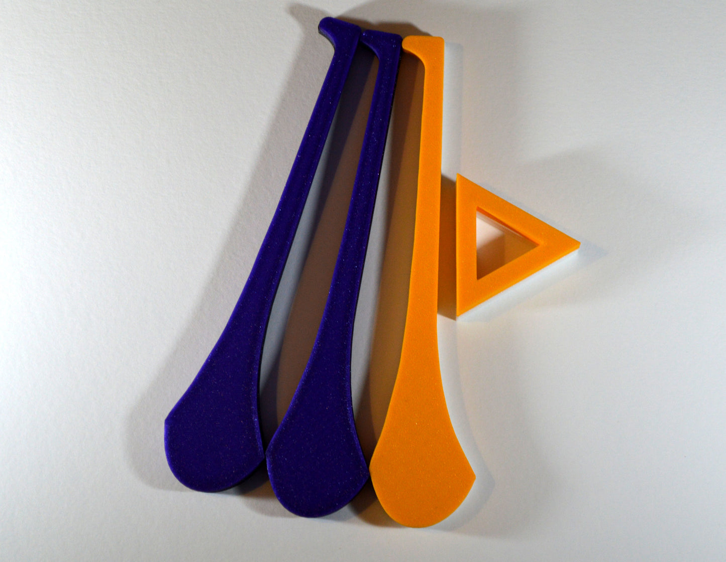 A display stand with a small hurley board, featuring purple and gold colours