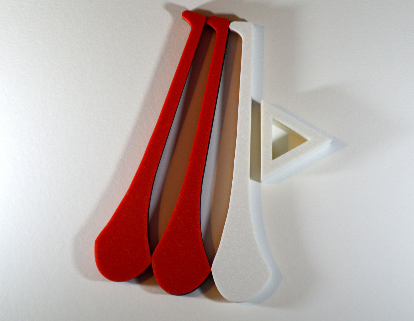 A display stand with a small hurley board, featuring red and white colours.