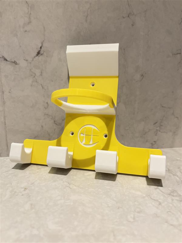 A yellow triple trinity hurley holder designed to hold equipment for the sport of hurling, featuring hooks for a helmet, sliotar, and multiple hurleys.