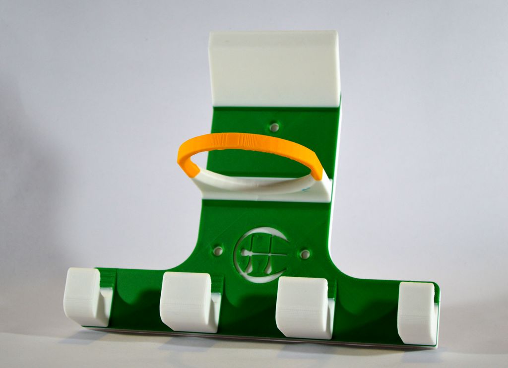A triple hurling holder in green, white and yellow.