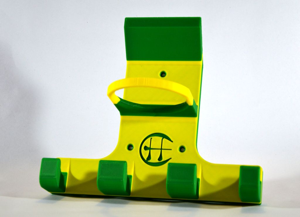 A green and yellow triple hurling holder on a white background