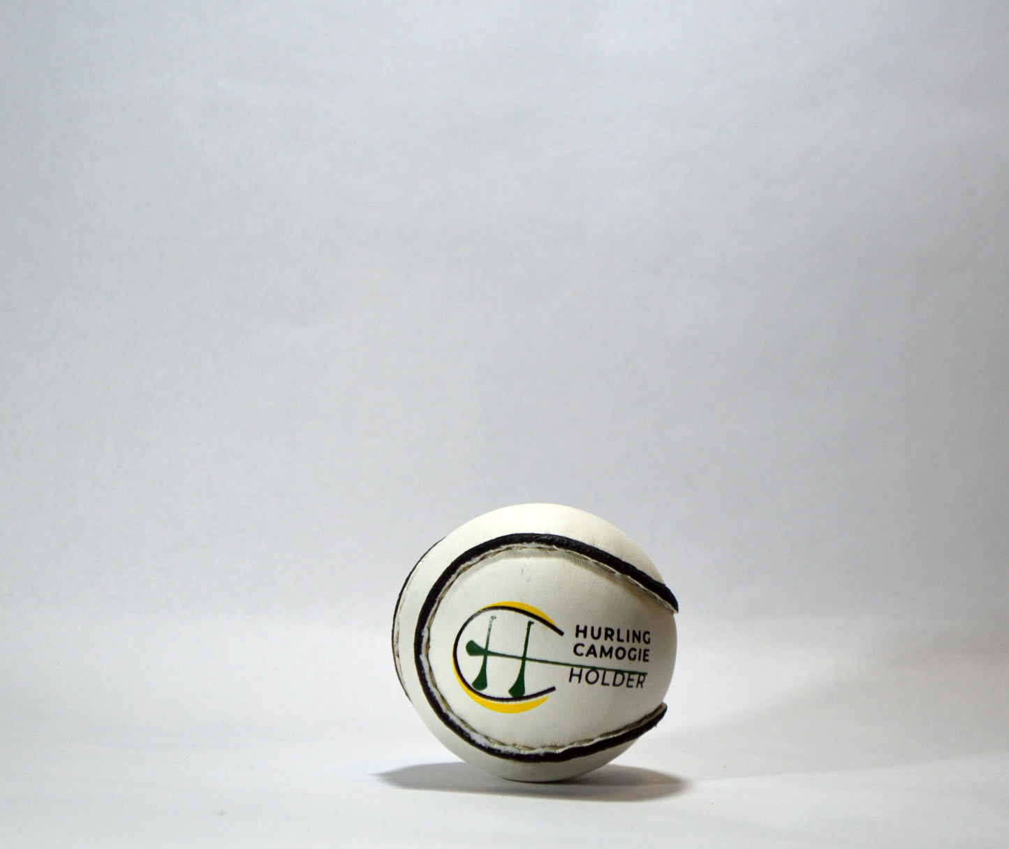 a white sliotar with hurling / camogie holder text