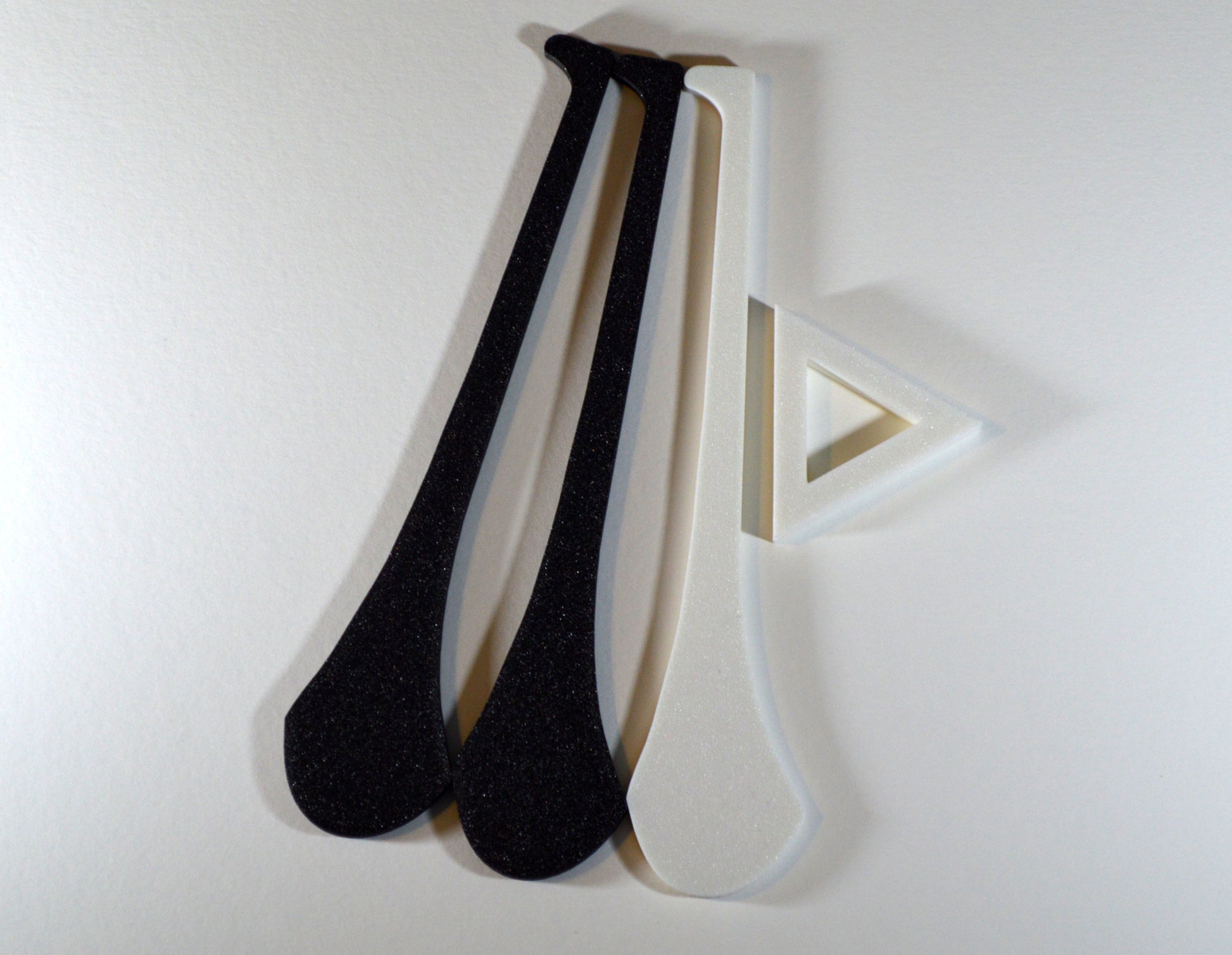 A display stand with a small hurley board, featuring black and white colours.