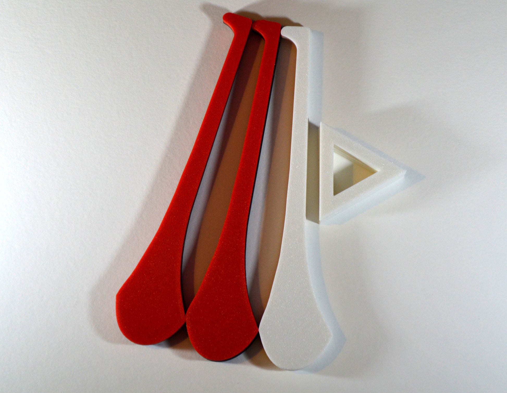 A display stand with a small hurley board, featuring red and white colours.