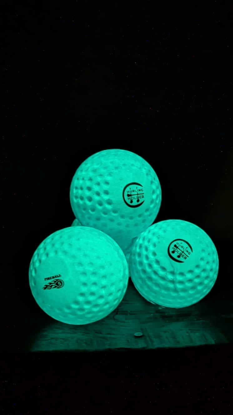 Three glowing blue speedballs on a black background