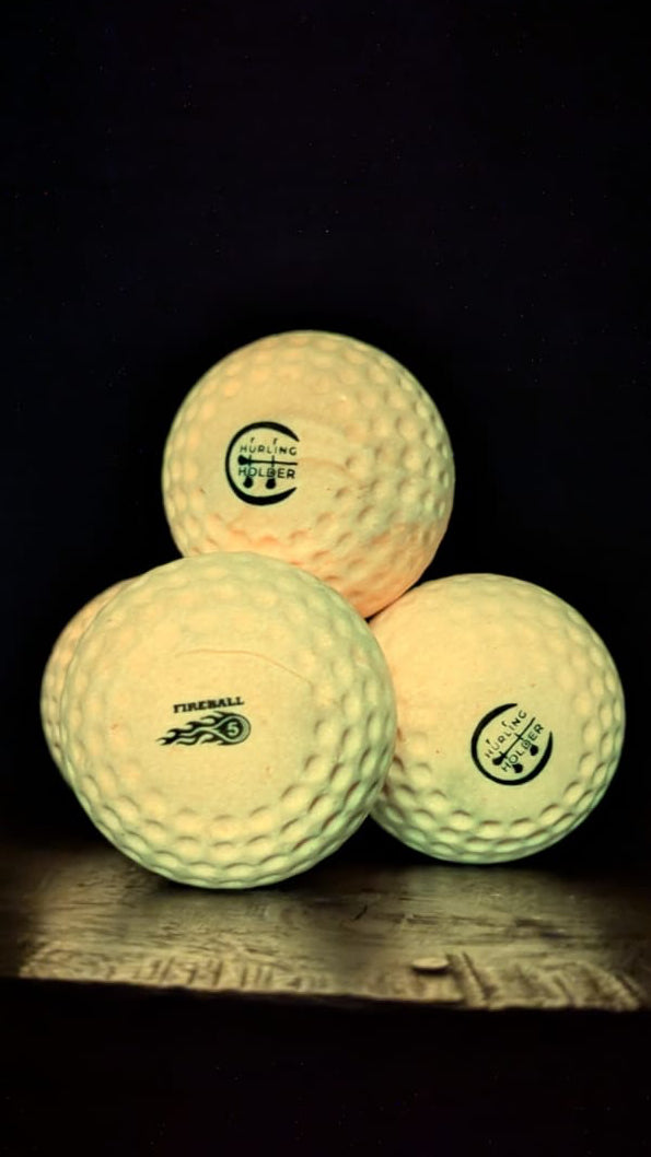 Three speedballs with visible branding on a dark background
