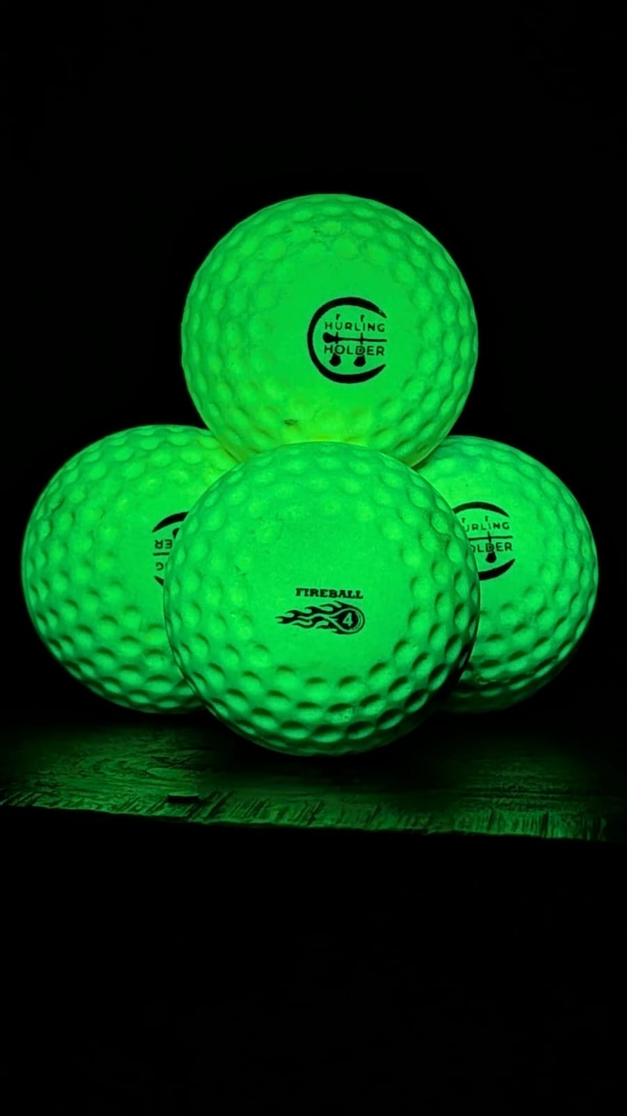 Three yellow speedballs with visible branding on a black background