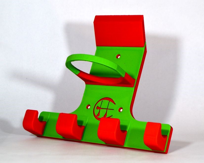 A 3D-printed hurling camogie holder  featuring bright green and red colours with a small circular logo on the face.
